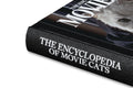 Close-up of the book cover titled "The Encyclopedia of Movie Cats" by A24, featuring illustrated feline characters on a colorful background.