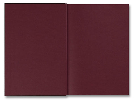 Open photography book titled "Faces and Phases" by MACK showing black-and-white portrait images on pages.