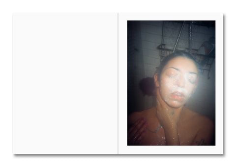 woman showering with soap covered face