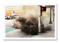 Smoke on a city street, featuring a red hand traffic signal.
