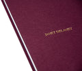 Close-up of the cover of the rare book "Red Eye to New York" by MACK, showcasing its textured red design and detailed typography.