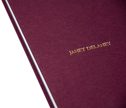 Close-up of the cover of the rare book "Red Eye to New York" by MACK, showcasing its textured red design and detailed typography.
