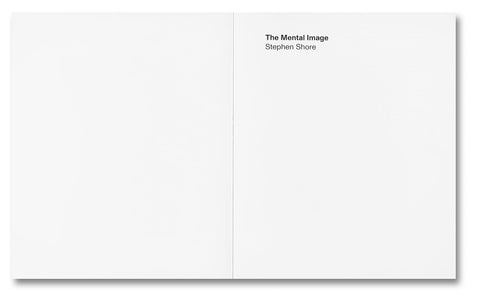 Open photography book titled The Mental Image by MACK, displaying black-and-white landscape photographs on a wooden table.