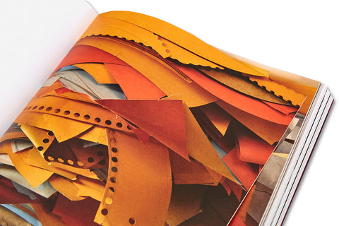 Open art book titled "House of Card" by MACK featuring intricate card-themed artwork on glossy pages.